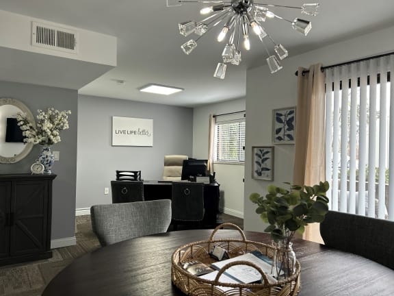 a dining area with a round table and a chandelier above it  at Timber Glen Apartments, Batavia, Ohio