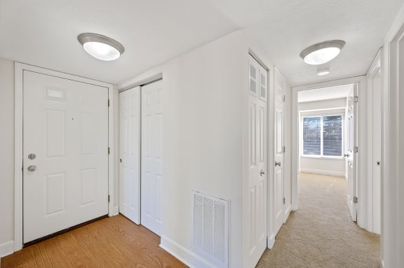 an empty room with white doors and a window at Harpers Point Apartments, Cincinnati,OH, 45249