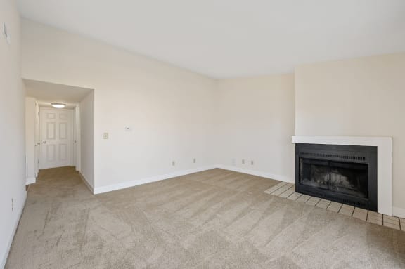 a living room with a fireplace and a carpeted floor at Harpers Point Apartments, Cincinnati, Ohio