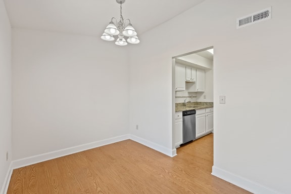 a living room and a kitchen with a wood floor at Harpers Point Apartments, Cincinnati, OH