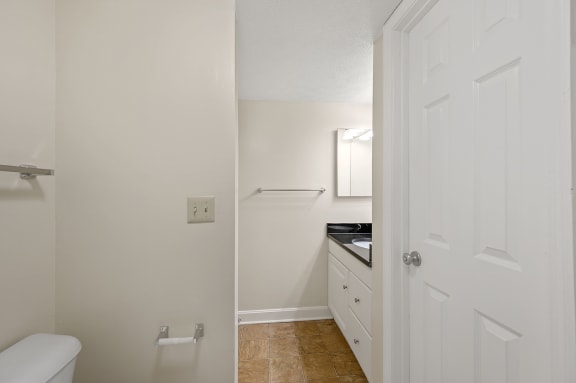 an empty kitchen with white cabinets and a white door at Harpers Point Apartments, Cincinnati,OH, 45249