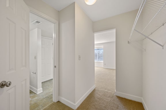 a bedroom with a closet and a door to a hallway at Harpers Point Apartments, Cincinnati, 45249