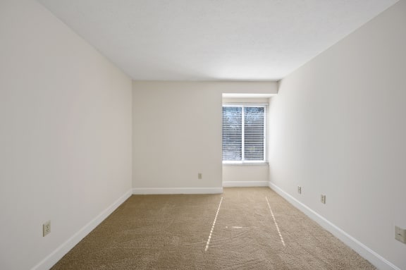 an empty room with carpet and a window at Harpers Point Apartments, Cincinnati, 45249