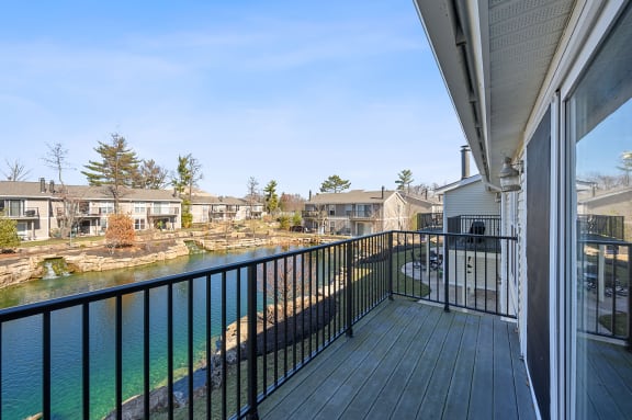 a balcony with a view of a river and some houses at Harpers Point Apartments, Ohio