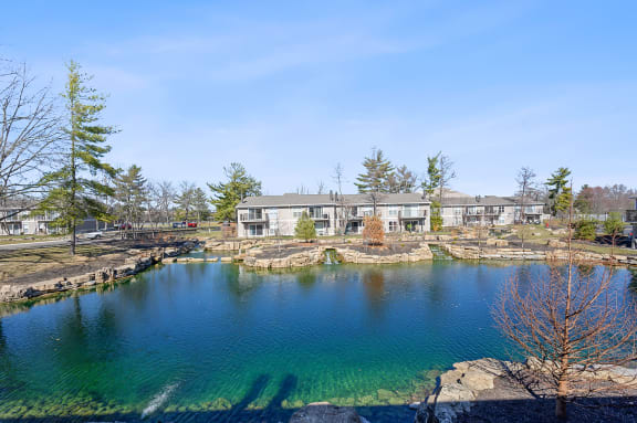 a pond with a house in the background at Harpers Point Apartments, Cincinnati, OH