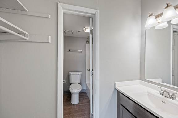A white toilet is in a small bathroom.