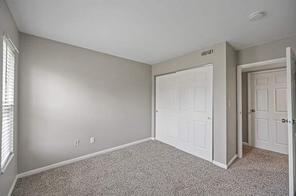 A room with a carpeted floor and white walls.