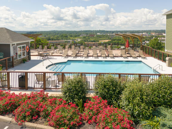 Swimming pool with lounge chairs and a deck with a resort style pool  at Hilltop Apartments,  45213-2638