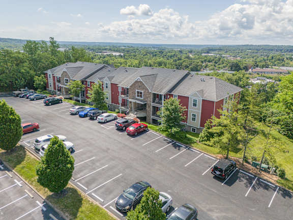 an aerial view of a parking lot and apartment buildings with cars parked  at Hilltop Apartments, Ohio, 45213-2638