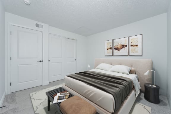 a bedroom with white walls and a bed with a brown blanket