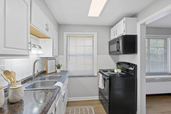 a kitchen with a sink and a stove and a microwave at Huntley Ridge, Kettering, OH, 45419