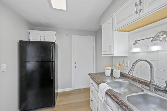 a kitchen with white cabinets and a black refrigerator at Huntley Ridge, Ohio, 45419