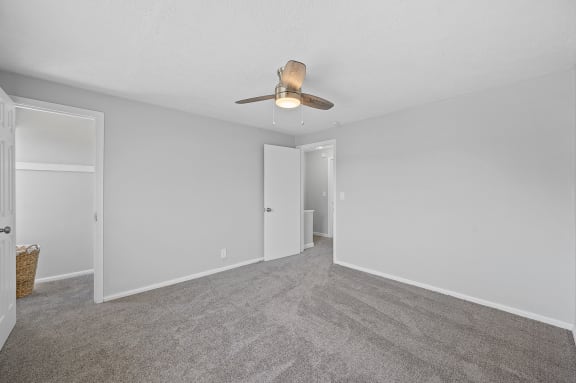a spacious living room with carpet and a ceiling fan at Huntley Ridge, Ohio