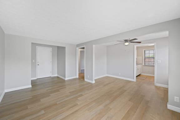 the living room and dining room of an empty house with a ceiling fan at Huntley Ridge, Ohio, 45419