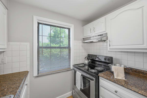 an empty kitchen with a stove and a window at Huntley Ridge, Ohio, 45419