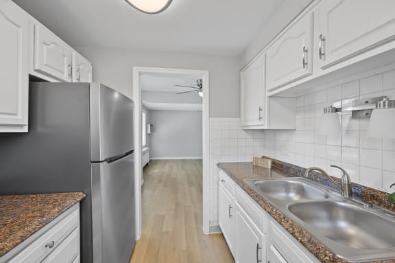 a kitchen with stainless steel appliances and white cabinets at Huntley Ridge, Kettering, OH, 45419