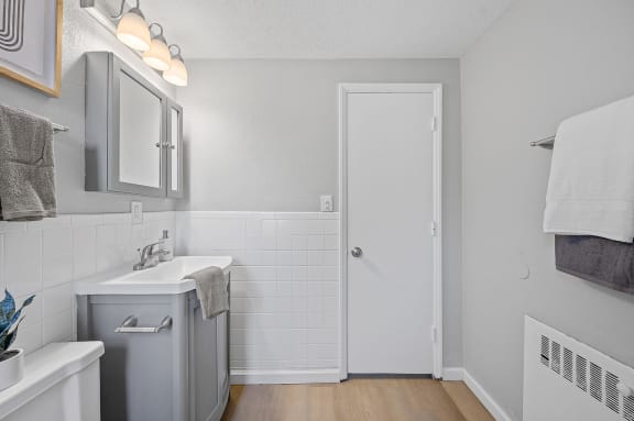 a small bathroom with a sink and a door at Huntley Ridge, Kettering
