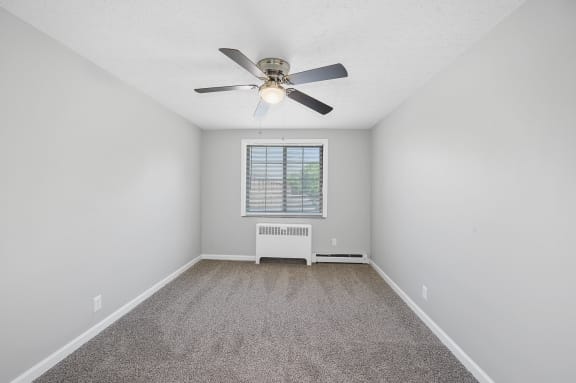 an empty room with a ceiling fan and a window at Huntley Ridge, Kettering