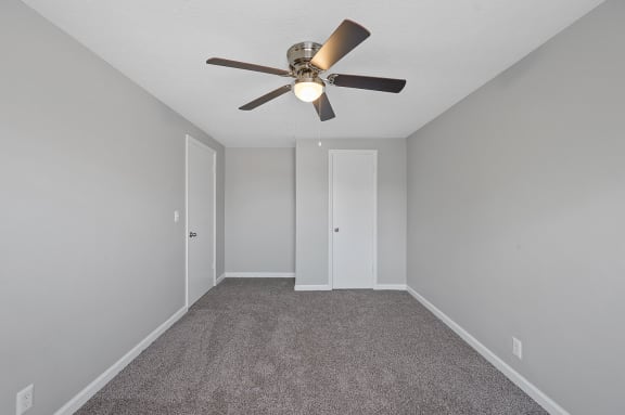 an empty room with a ceiling fan and a carpet at Huntley Ridge, Kettering, OH, 45419