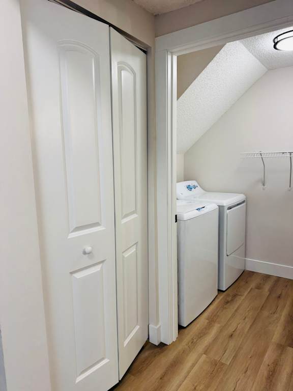 A white laundry room with a washer and dryer.