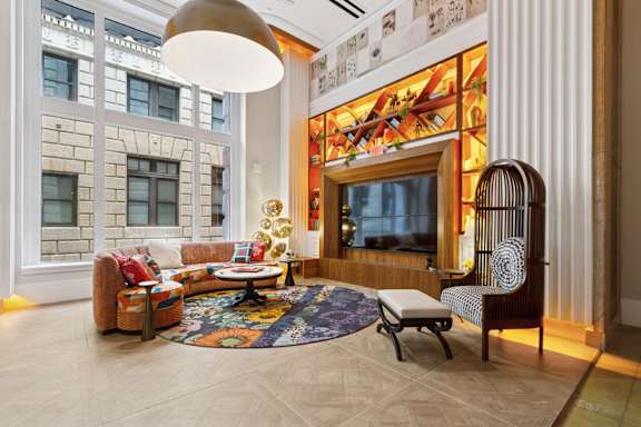 A living room with a couch, chair, and rug.