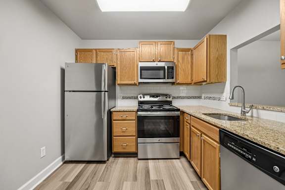 A kitchen with wooden cabinets and stainless steel appliances.