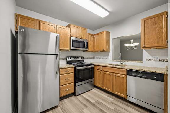 A kitchen with wooden cabinets and stainless steel appliances.