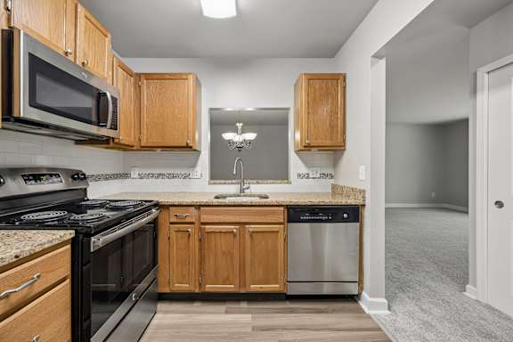 A kitchen with wooden cabinets and stainless steel appliances.