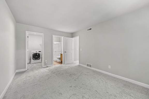 A room with a washer and dryer in it.