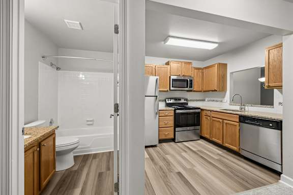 A modern kitchen with wooden cabinets and stainless steel appliances.