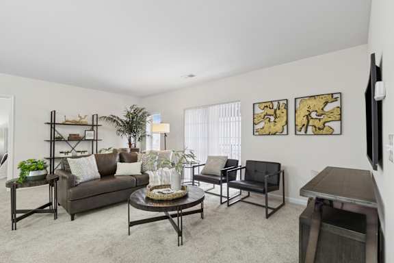 A living room with a couch, chairs, and a coffee table. at Roebling Row, Kentucky, 41011-1720