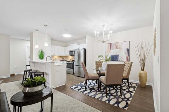 A modern kitchen with a dining table and chairs. at Roebling Row, Kentucky