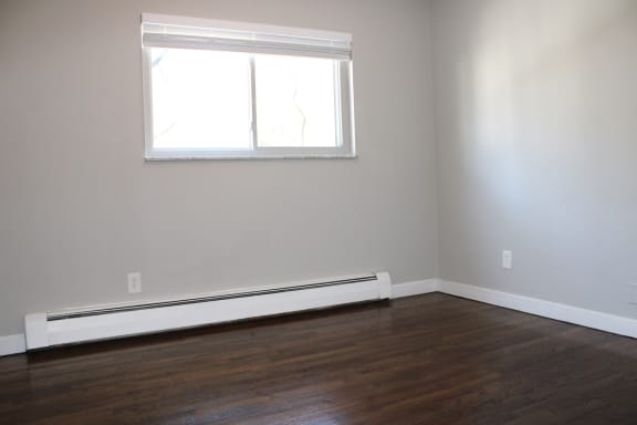 an empty room with a window and hardwood floors at Cincinnati Premier Living*, Cincinnati, OH