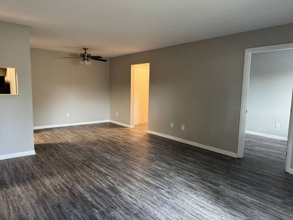 A room with a ceiling fan and a light switch at Quail Run Apartments, Columbus, IN, 47201