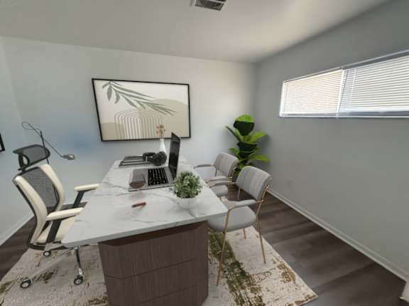 A modern office space with a desk, chairs, and a plant.