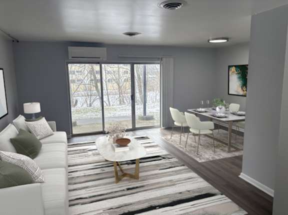 A modern living room with a white sofa and a coffee table.