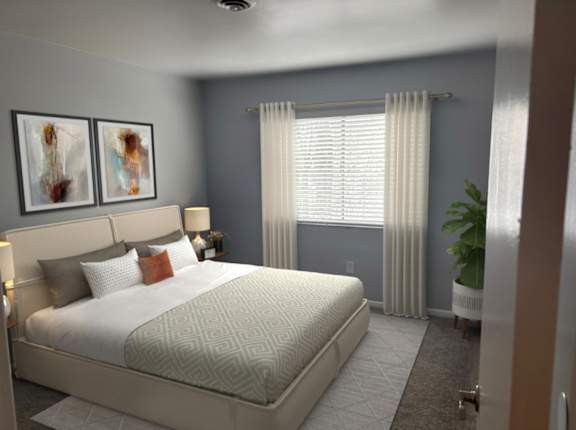 A bedroom with a large bed and two framed pictures on the wall.