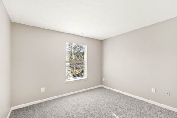 A room with grey carpet at Waterfront Pointe, Indianapolis, IN 46214