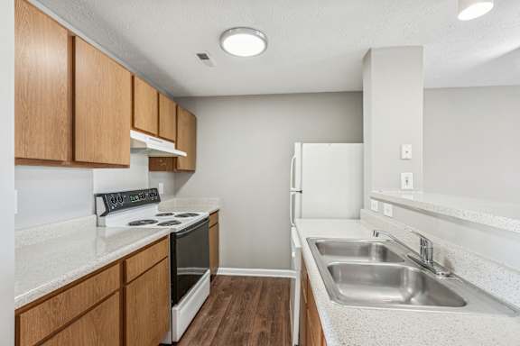 A kitchen with a stove and sink at Waterfront Pointe, Indianapolis Indiana