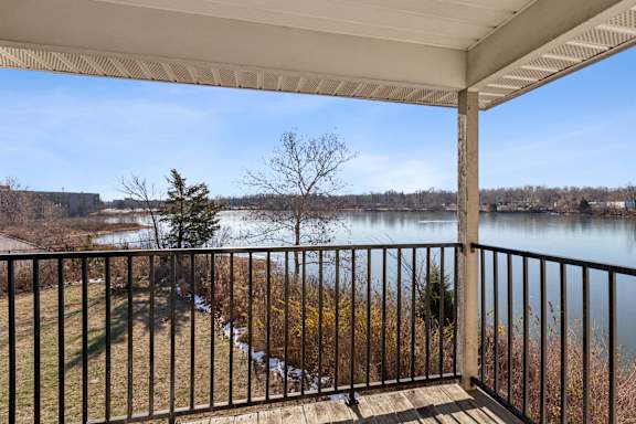 A balcony with a metal railing at Waterfront Pointe, Indianapolis, IN