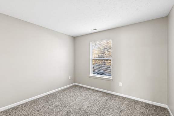 room with a carpeted floor and grey walls at Waterfront Pointe, Indianapolis
