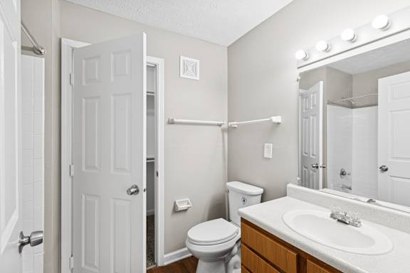 A white bathroom with hangers at Waterfront Pointe, Indianapolis, IN