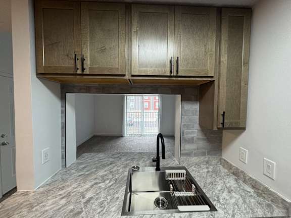 A kitchen with a sink and cabinets.