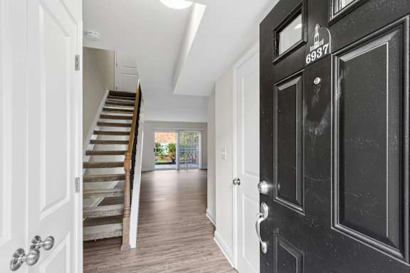 A black door with the number 6937 on it is on the right.