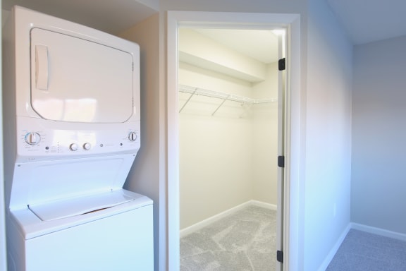 a laundry room with a washer and dryer and a closet