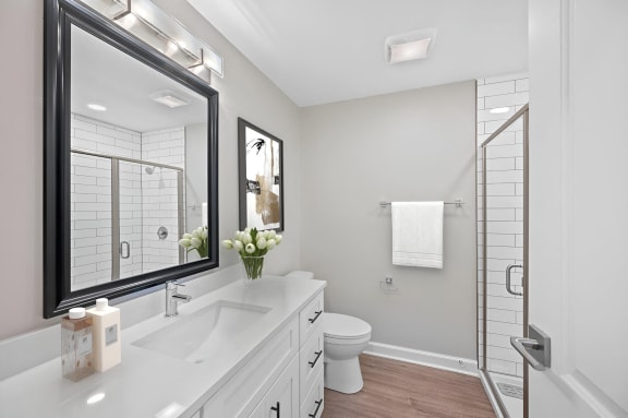 a white bathroom with a large mirror and a toilet at Indian Creek Apartments*, Ohio, 45236