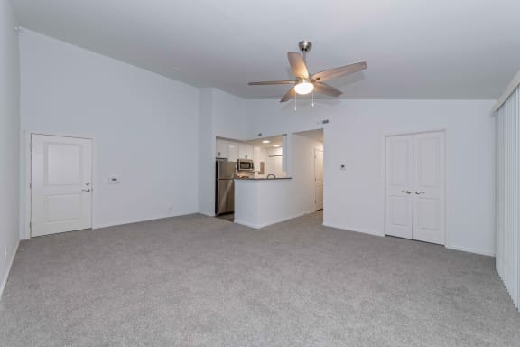an empty living room with a ceiling fan and a kitchen at Ivy Hills Living Spaces, Ohio, 45244