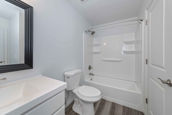 a bathroom with a toilet and a tub and a sink at Ivy Hills Living Spaces, Ohio, 45244