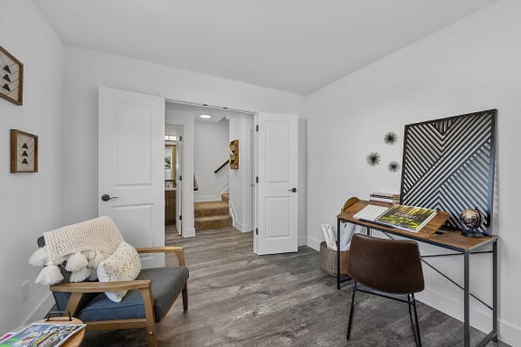 a home office with a desk and a chair and a hallway with a staircase at Ivy Hills Living Spaces, Cincinnati, OH, 45244