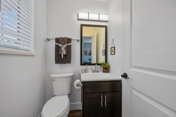a bathroom with a toilet sink and a mirror at Ivy Hills Living Spaces, Cincinnati, OH, 45244